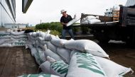 Francis Bruhm, Project Manager for general contractor G&R Kelly, places sandbags around the doors of the Nova Scotia Power building in Halifax, Nova Scotia, Canada September 23, 2022. Reuters/Ingrid Bulmer