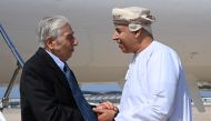 Baquer Namazi, 85, an Iranian American who was jailed in Iran on spying charges, that the United States called baseless, shakes hands with an Omani official upon his arrival in Muscat on October 5, 2022. Oman News Agency/Handout via REUTERS 