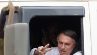 Brazil's President and candidate for re-election Jair Bolsonaro gestures while driving a truck during the taping of a television advertisement for his presidential campaign in Brasilia, Brazil, on October 7, 2022. (REUTERS/Ueslei Marcelino)