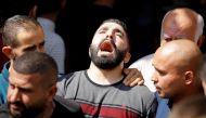The brother of Palestinian Ahmad Daraghmeh (19), who was killed by Israeli forces, mourns during his funeral in Jenin in the Israeli-occupied West Bank on October 8, 2022. REUTERS/Raneen Sawafta