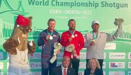 Qatar's Rashid Saleh Al Athba celebrates on the podium with Egypt’s Azmy Mehelba USA’s Vincent Hancock.