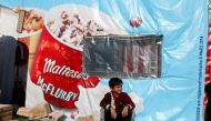 FILE PHOTO: A Syrian refugee boy sits outside a tent at a camp in Bar Elias, in the Bekaa Valley, Lebanon January 13, 2020. Picture taken January 13, 2020. REUTERS/Mohamed Azakir