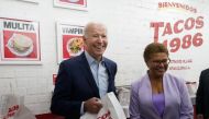 US President Joe Biden and Rep. Karen Bass (D-CA) react during visit to a taco shop in Los Angeles, California, US, on October 13, 2022. REUTERS/Kevin Lamarque