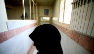 File photo of a female prison guard stands along a corridor in Tehran's Evin prison June 13, 2006. Reuters/Photo