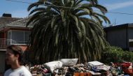 Piles of debris line a residential street following severe flooding and damage to homes in the Maribyrnong suburb of Melbourne, Australia, October 17, 2022. REUTERS/Loren Elliott