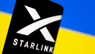 Starlink logo is seen on a smartphone in front of displayed Ukrainian flag in this illustration taken February 27, 2022. (REUTERS/Dado Ruvic)