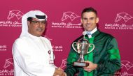 QREC Racing Manager Abdulla Rashid Al Kubaisi after handing over the trophy to jockey Tomas Lukasek. PIC Juhaim/QREC 