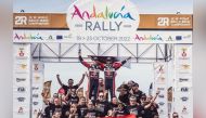 Qatar's Nasser Saleh Al Attiyah and his French co-driver Mathieu Baumel celebrate with their crew after winning the FIA World Rally-Raid Championship drivers' title.
