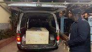 The wooden coffin containing the body of Pakistani journalist Arshad Sharif, who was shot dead when police hunting car thieves opened fire on the vehicle he was traveling in as it drove through their roadblock without stopping, is loaded into a courtesy van at the Chiromo mortuary in Nairobi, Kenya, on October 24, 2022. REUTERS/Thomas Mukoya