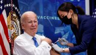 US President Joe Biden receives an updated coronavirus disease (COVID-19) vaccine while launching a new plan for Americans to receive booster shots and vaccinations, onstage in an auditorium on the White House campus in Washington, US, October 25, 2022. (REUTERS/Jonathan Ernst)