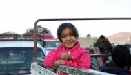 A girl stands on a pick-up truck as Syrian refugees prepare to return to Syria from Wadi Hmayyed, on the outskirts of the Lebanese border town of Arsal, Lebanon October 26, 2022. Reuters/Mohamed Azakir