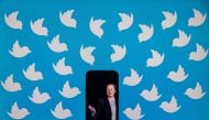 This file illustration photo taken on August 5, 2022 shows a cellphone displaying a photo of Elon Musk placed on a computer monitor filled with Twitter logos in Washington, DC. (SAMUEL CORUM / AFP)