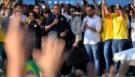 Brazilian President and re-election candidate Jair Bolsonaro (C) speakss during a campaign rally at the Campo Grande neighborhood, west zone of Rio de Janeiro, Brazil, on October 27, 2022. MAURO PIMENTEL / AFP
