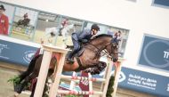 Faleh Suwead Al Ajami guides Ambre De Beaufour over a fence.