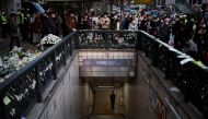 A police officer stands guard at the exit of a subway station as people gather to pay their respects following a crowd crush that happened during Halloween festivities, in Seoul, South Korea, November 1, 2022. REUTERS/Kim Hong-Ji
