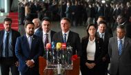 Brazilian President Jair Bolsonaro (C) makes a statement for the first time since Sunday's presidential run-off election, at Alvorada Palace in Brasilia, on November 1, 2022.  (Photo by EVARISTO SA / AFP)