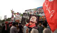 Supporters of former Pakistani prime minister Imran Khan, take part in a protest near the container truck a day after the assassination attempt on Khan, at the cordoned-off site of a gun attack in Wazirabad on November 4, 2022. (AFP/Aamir QURESHI)