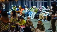This picture taken on November 4, 2022 shows fans of K-pop music group NCT127 gathered outside the concert venue after the event was stopped in Serpong, Banten provice. Photo by Fajrin Raharjo / AFP