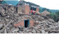 People stand outside the ruins of collapsed houses after an earthquake struck early Wednesday, in the western district of Doti, Nepal November 9, 2022. Nepal Army/Handout via Reuters