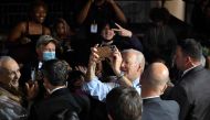 US President Joe Biden takes pictures with supporters during a rally on the eve of the US midterm elections, at Bowie State University in Bowie, Maryland, on November 7, 2022. (AFP/Mandel Ngan)
