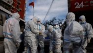 Pandemic prevention workers in protective suits prepare to enter an apartment compound that was placed under lockdown as outbreaks of the coronavirus disease (COVID-19) continue in Beijing, China, November 12, 2022. REUTERS/Thomas Peter