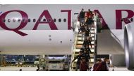Qatar players and officials arrive in Doha on a Qatar Airways flight.