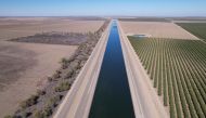 The dried out Arroyo Pasajero Creek is seen alongside an aqueduct in Huron, California, U.S. on October 25, 2022. REUTERS/Nathan Frandino
