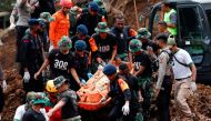 Indonesia rescue members carry a victims body from the site of a landslide caused by the earthquake in Cugenang, Cianjur, West Java province, Indonesia, November 22, 2022. REUTERS/Ajeng Dinar Ulfiana

