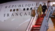 French President Emmanuel Macron (R) and his wife Brigitte Macron disembark from their plane upon arrival at Joint Base Andrews in Maryland on November 29, 2022. (Photo by Ludovic MARIN / AFP)
 