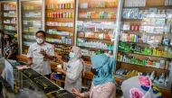 Health officers inspect medicinal syrups containing ethylene glycol and diethylene glycol at a pharmacy in Bandung, West Java province, Indonesia, October 26, 2022, in this photo taken by Antara Foto. Antara Foto/Raisan Al Farisi/via REUTERS

