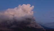 Mount Semeru spews smoke and ash in Lumajang on December 4, 2022. (Photo by Agus Harianto / AFP)