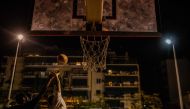 Children who are second-generation migrants play basketball at a basketball court in the centre of Athens on October 8, 2022. Photo by Angelos Tzortzinis / AFP
