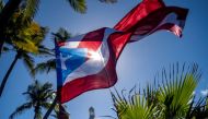 A person holds a Puerto Rican flag in front of the Capitol building during a protest of teachers demanding salary increase and better working conditions, in San Juan, Puerto Rico, on February 9, 2022. File Photo / Reuters