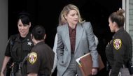 In this file photo taken on May 26, 2022 Actor Amber Heard leaves for the day during the Depp vs Heard deformation trial at Fairfax County Court in Fairfax, Virginia.  (Photo by Brendan Smialowski / AFP)