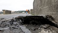 Large crack in bridge surface is seen after a strong 6.4-magnitude earthquake struck off the coast of northern California, in Rio Dell, California, U.S. December 20, 2022. REUTERS/Fred Greaves