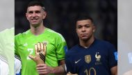 In this file photo taken on December 18, 2022, Argentina's goalkeeper Emiliano Martinez and France's forward Kylian Mbappe pose on the podium after receiving the Golden Glove and Golden Boot awards respectively, during the Qatar 2022 World Cup trophy ceremony after the football final match between Argentina and France at Lusail Stadium in Lusail, north of Doha. (Photo by Franck Fife / AFP)