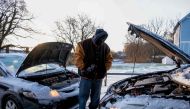 Antonio Smothers jumps his vehicle on December 23,2022 after winter storm Elliot moved through the Middle Tennessee region leaving behind freezing rain, snow and below freezing temperatures, in Nashville, Tennessee on December 23, 2022. (Photo by Seth Herald / AFP)