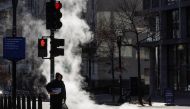 Pedestrians walk in the cold near the White House, as temperatures drop throughout the day as part of a large winter weather system across the country, in Washington on December 23, 2022. REUTERS/Jonathan Ernst