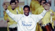 In this file photo taken on October 31, 1990 Pele opens his arms as he acknowledges cheers from a crowd of spectators during a ceremony in Milan to celebrate his fiftieth birthday. (Photo by Gerard MALIE / AFP)