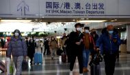 Travellers walk with their luggage at Beijing Capital International Airport, amid the coronavirus disease (COVID-19) outbreak in Beijing, China December 27, 2022. Reuters/Tingshu Wang