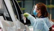 File photo: A health worker collects a saliva sample in a sealed package at a drive-thru coronavirus disease (COVID-19) saliva testing site, in Pasay city, Metro Manila, Philippines, February 3, 2021. )REUTERS/Lisa Marie David)