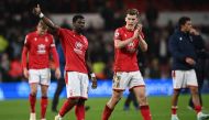 Nottingham Forest's Ivorian Coast defender Serge Aurier (second left) gestures to fans on the pitch after the English Premier League football match between Nottingham Forest and Chelsea at The City Ground in Nottingham, central England, on January 1, 2023.  (Photo by Paul ELLIS / AFP) 
