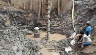 Rescuers gather at the site of where a 10-year-old boy is thought to be trapped in a 35-metre deep shaft at a bridge construction area in Vietnam's Dong Thap province on January 2, 2023.  Photo by AFP