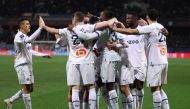 Marseille's Portuguese defender Nuno Tavares (centre) celebrates with teammates after scoring his team's first goal during the French L1 football match between Montpellier Herault SC and Olympique de Marseille (OM) at Stade de la Mosson in Montpellier, southern France, on January 2, 2023. (Photo by Pascal GUYOT / AFP)