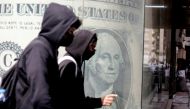 People walk past a currency exchange point, showing an image of the US dollar in Cairo, Egypt, on March 22, 2022. File Photo / Reuters