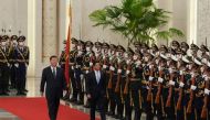 This handout photograph released by Philippine's Office of the Press Secretary and taken on January 4, 2023, shows China's President Xi Jinping and Philippine's President Ferdinand Marcos Jr during a welcome ceremony at the Great Hall of People in Beijing. (Photo by Philippines's Office of the Press Secretary / AFP)