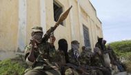 File photo: Al Shabaab soldiers sit outside a building during patrol along the streets of Dayniile district in Southern Mogadishu, March 5, 2012. (REUTERS/Feisal Omar)