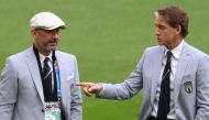 In this file photo taken on June 26, 2021 Italy's coach Roberto Mancini (right) talks with national team staff member Gianluca Vialli (left) ahead of the UEFA EURO 2020 round of 16 match between Italy and Austria at Wembley Stadium in London on June 26, 2021.(Photo by Laurence Griffiths / POOL / AFP)