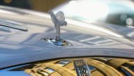 The mascot, the so-called 'Spirit of Ecstasy' or 'Emily', and the company logo are seen on the bonnet of a Rolls-Royce car in Zurich, Switzerland March 30, 2021. REUTERS/Arnd Wiegmann/File Photo