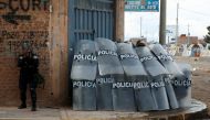 Peruvian police officers operate as demonstrators hold a protest demanding early elections and the release of Peruvian ousted leader Pedro Castillo, in Juliaca, Peru, January 8, 2023. (REUTERS/Hugo Courotto) 
